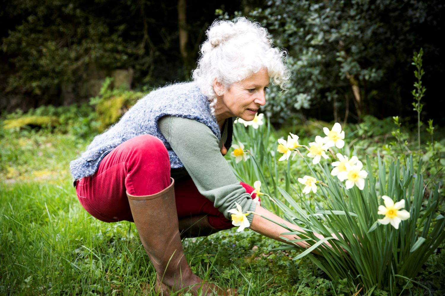 Elderly woman preparing her garden for spring