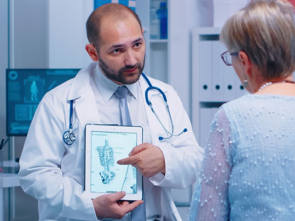 GP giving advice on Osteoporosis to an elderly woman