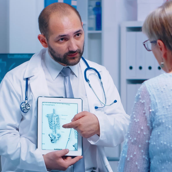 GP giving advice on Osteoporosis to an elderly woman