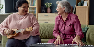 Elderly woman playing musical instruments with her friend