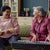 Elderly woman playing musical instruments with her friend