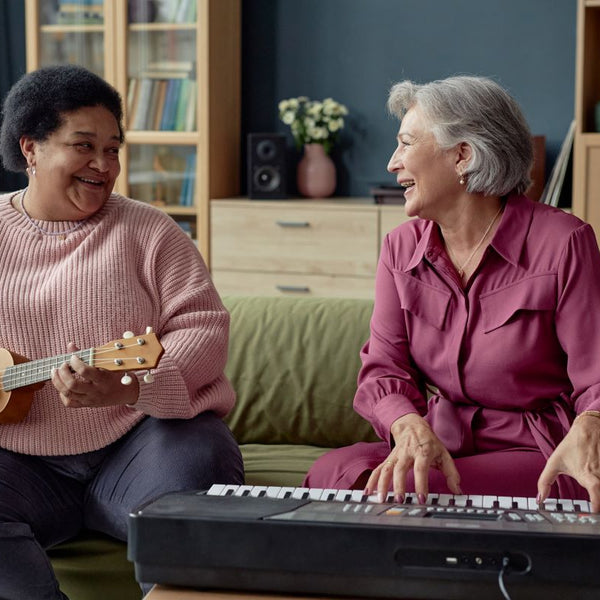 Elderly woman playing musical instruments with her friend