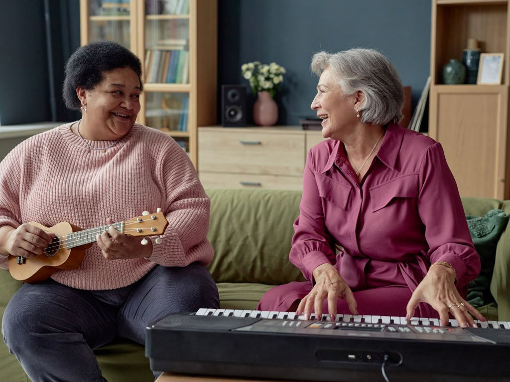 Elderly woman playing musical instruments with her friend