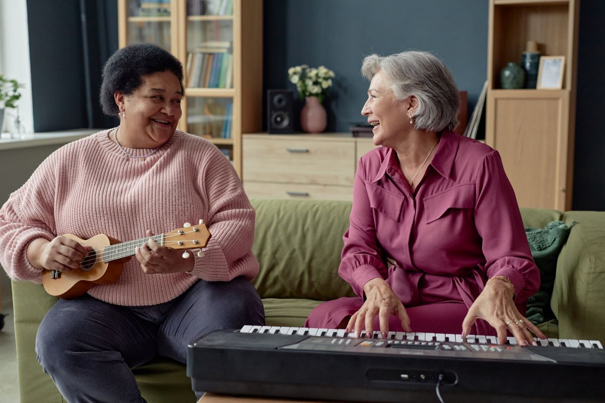 Elderly woman playing musical instruments with her friend