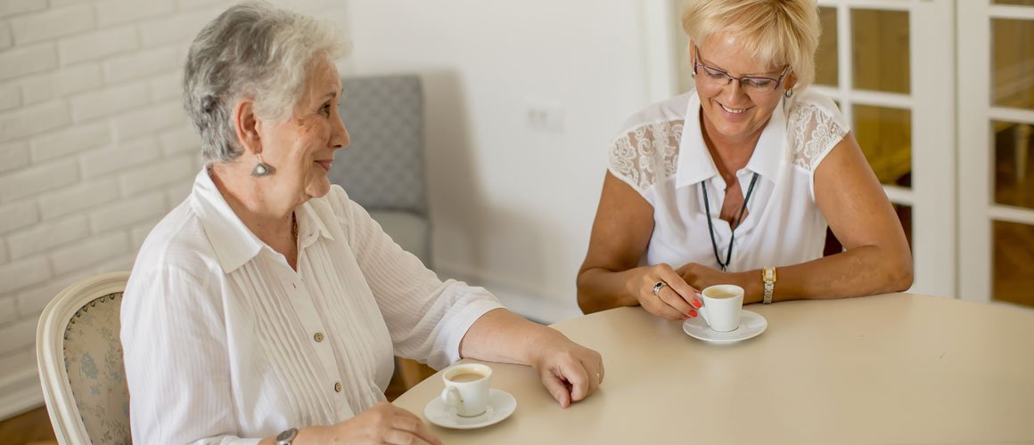 Old women enjoying a cup of tea in their home