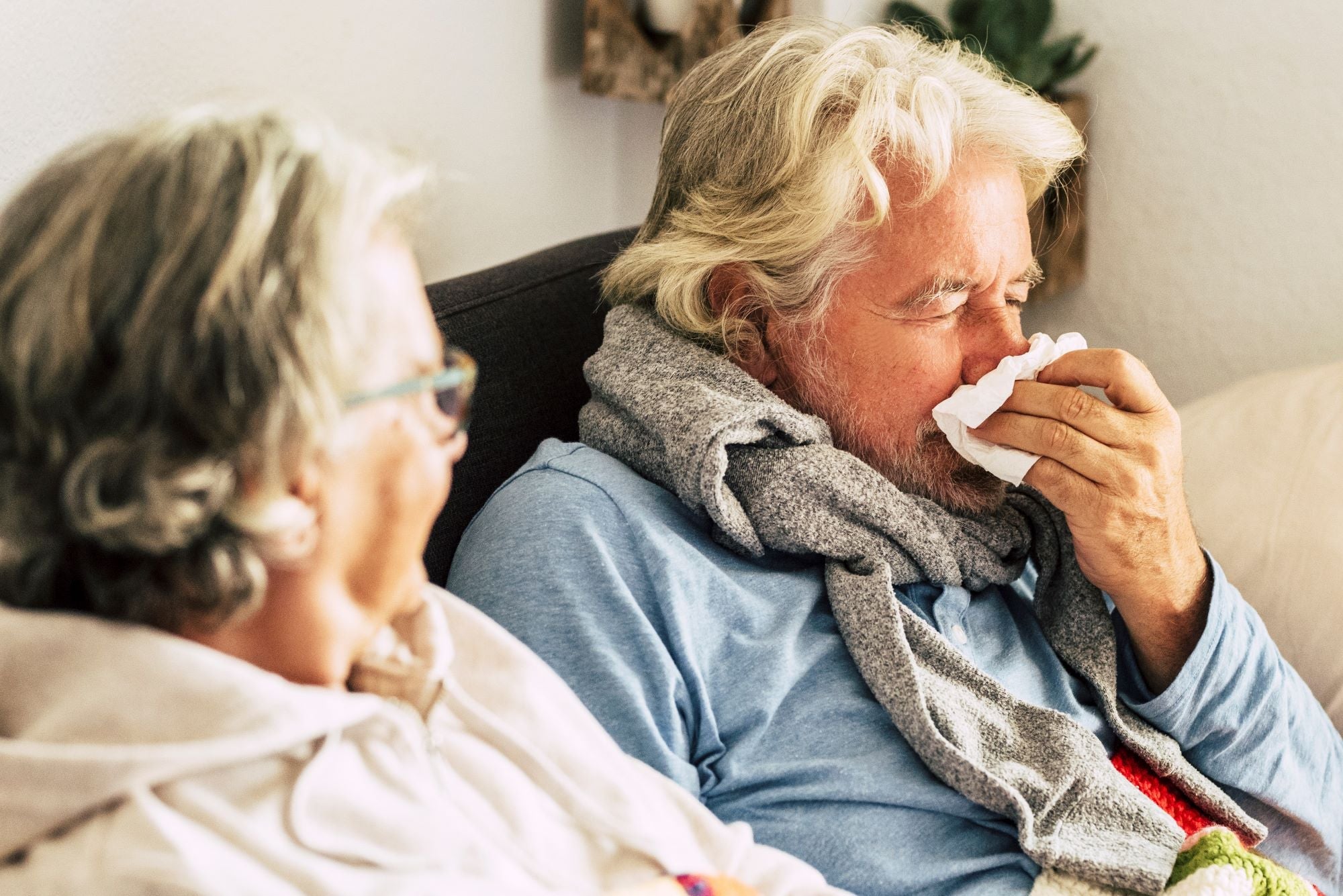 Man with allergy symptoms at home