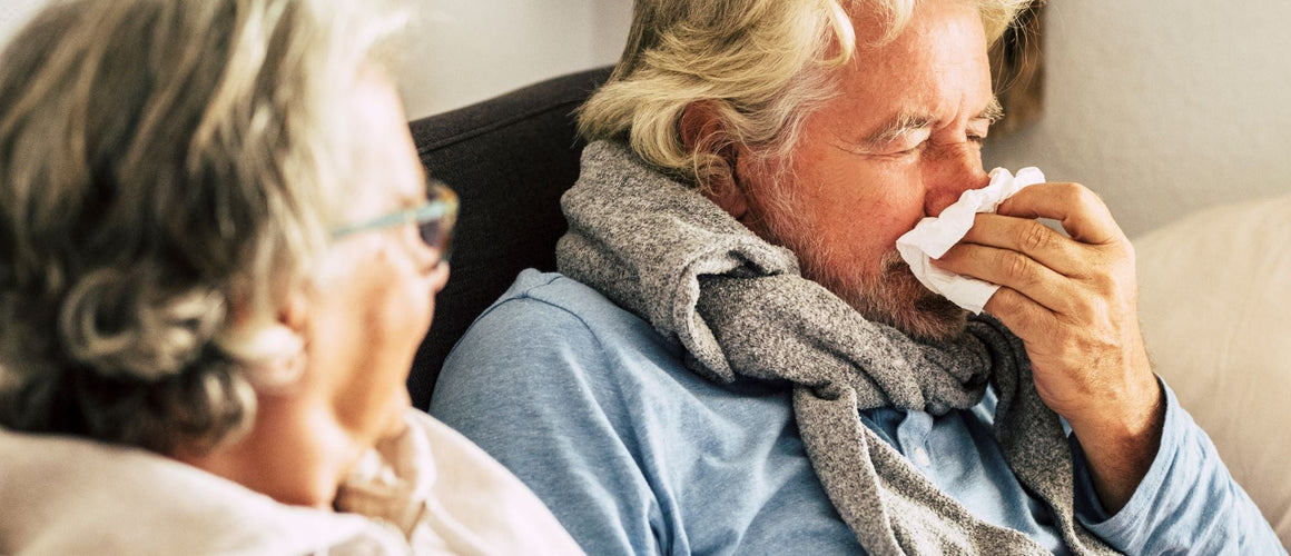 Man with allergy symptoms at home