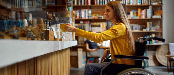 Woman in wheelchair in coffee shop