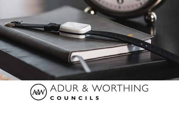 Small electronic device on a notebook with 'ADUR & WORTHING COUNCILS' branding at the bottom.