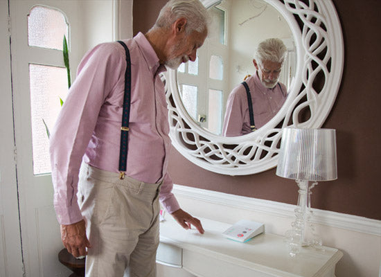 Man looking at in home alarm base unit