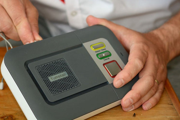 Engineer with telecare equipment