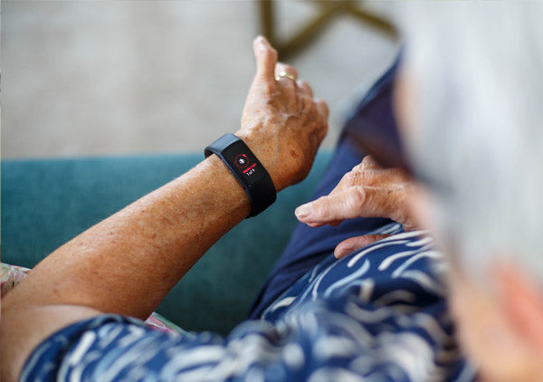 Person wearing a smartwatch with a blurred background