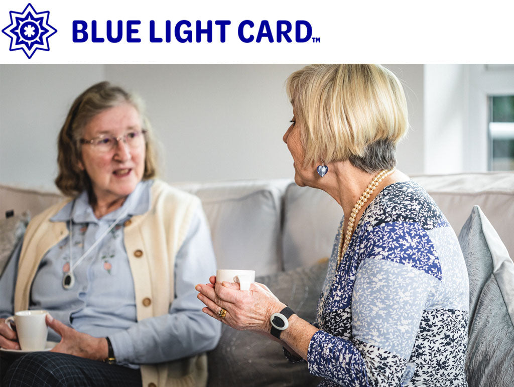 Two women sitting on a couch with 'Blue Light Card' logo above them.