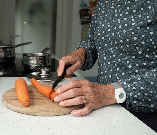 Older person with bracelet alarm on wrist