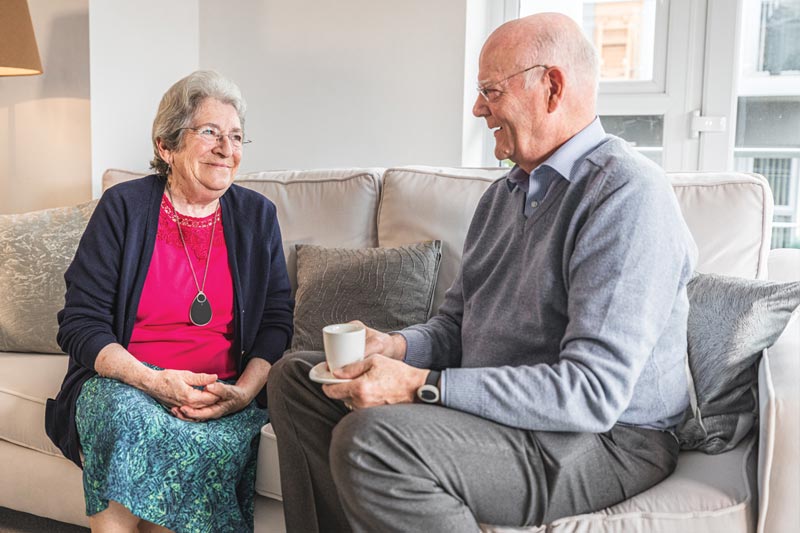 Elderly couple with emergency alarm pendants