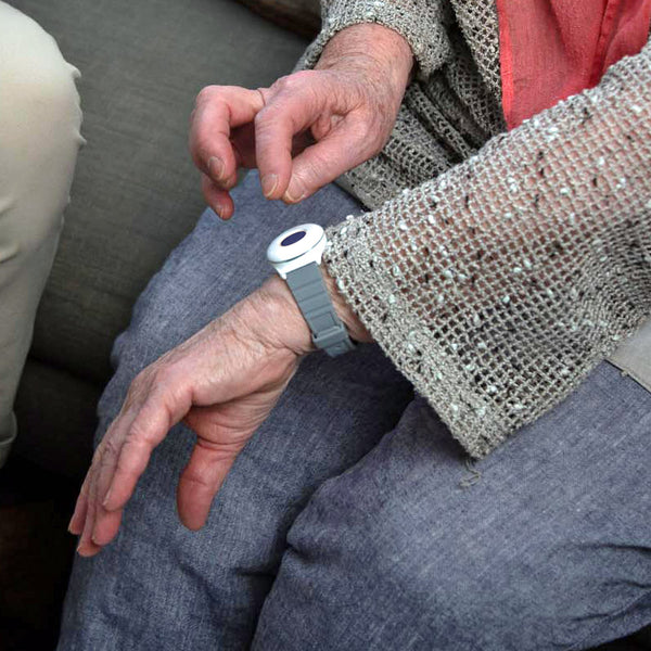 Older person pressing a fall alarm button