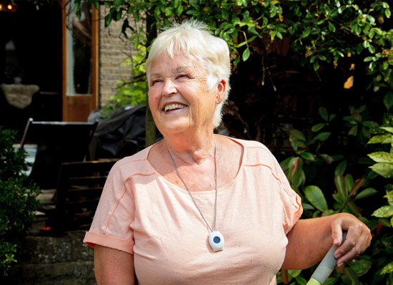 Older lady in garden wearing neck personal alarm