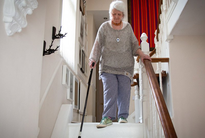 Elderly lady walking down stairs