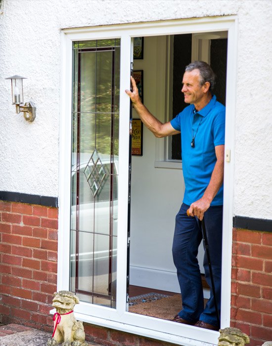 Man at door to home