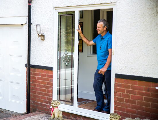 Man with alarm standing by door