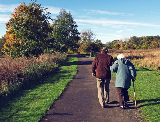 Elderly couple walking outside