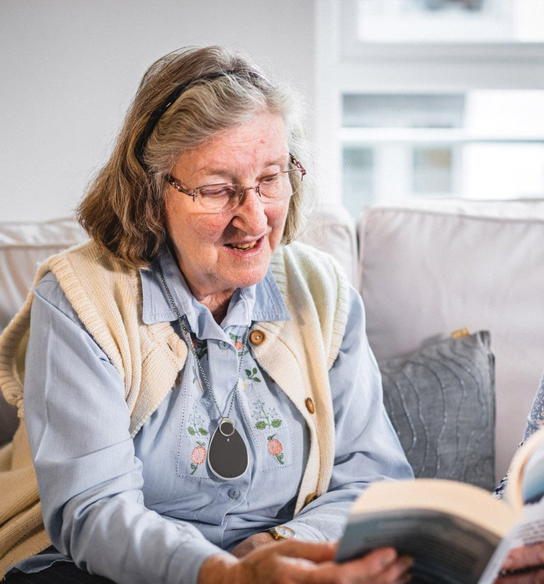 Woman reading a book on a couch in a cozy living room.