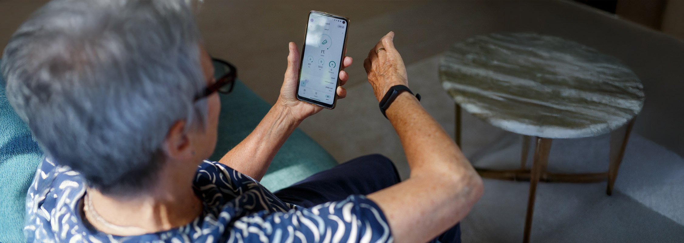 Person holding a smartphone with a blurred background