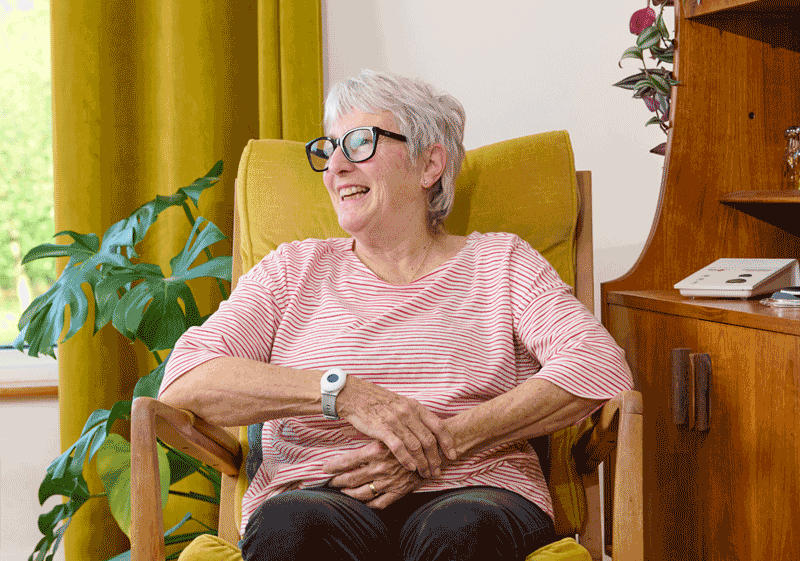Elderly person wearing personal alarm on wrist
