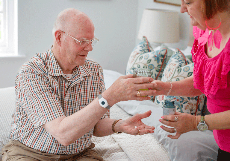 Senior man getting help from adult daughter