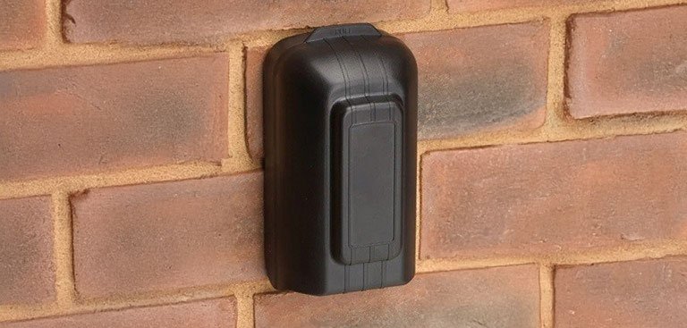 Black key safe on brick wall