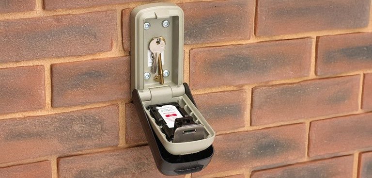 Open key safe on brick wall
