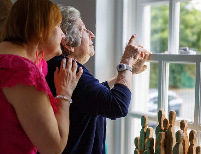 Two people looking out a window with a focus on emotional connection.