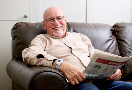 Elderly man wearing personal alarm pendant