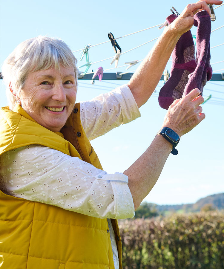 Lady outside wearing personal alarm watch on wrist
