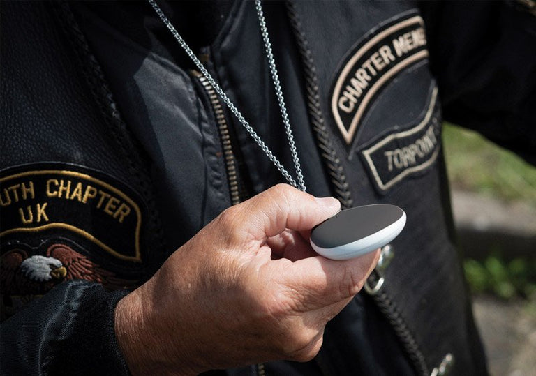 Biker holding alarm pendant