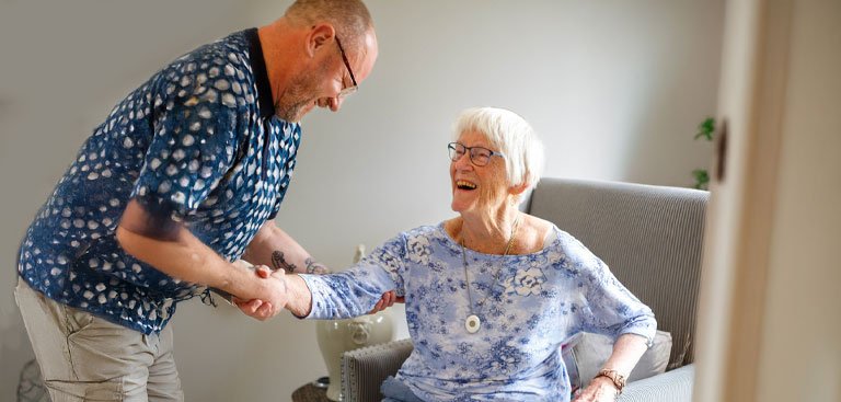Man and older woman with personal alarm