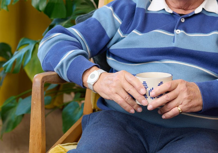 Elderly man wearing emergency alarm button