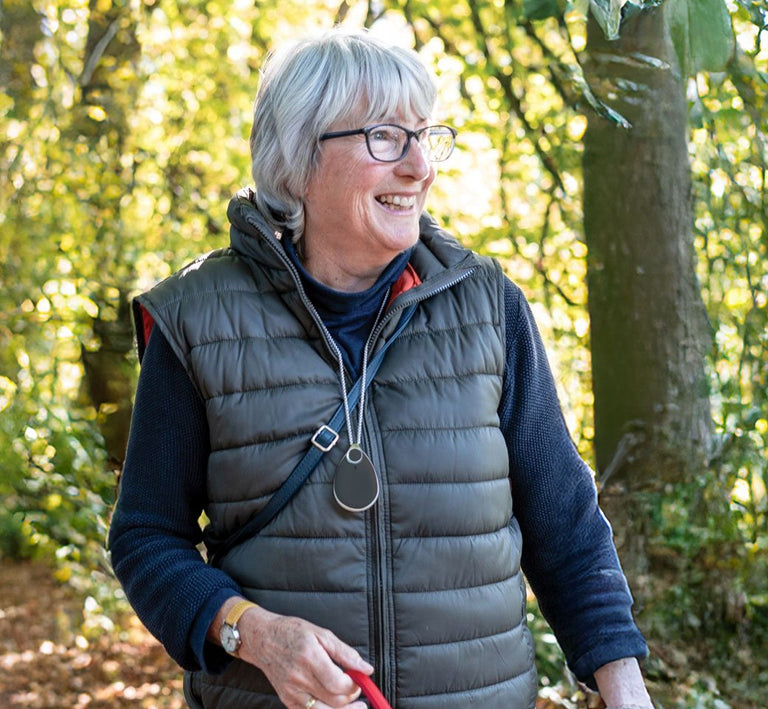 Older woman outdoors with GPS alarm pendant