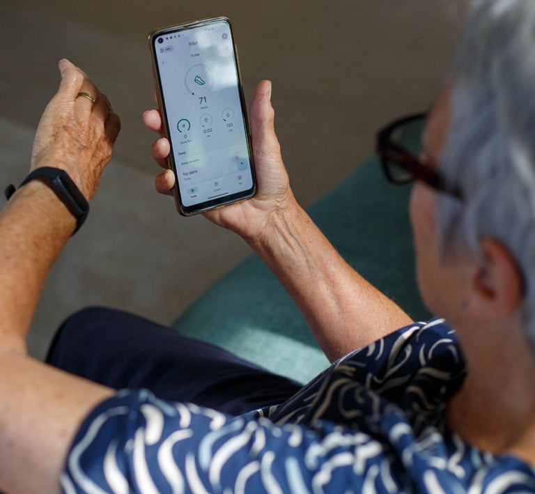 Older person looking at Fitbit app