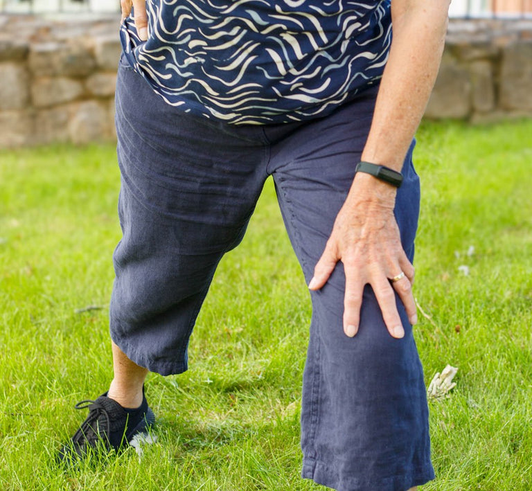 Close up of older person exercising whilst wearing fitbit