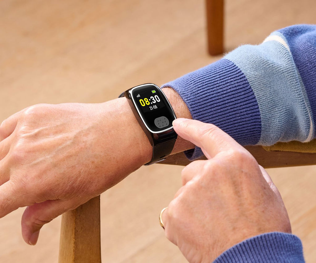 Person using a personal alarm watch with a blurred background