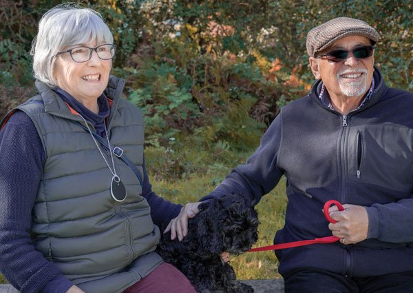 Elderly couple wearing GPS tracker pendant