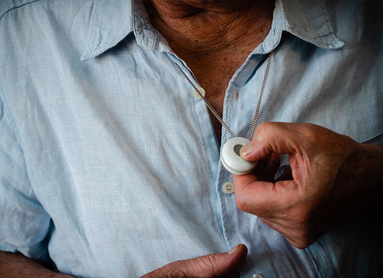 Man pressing pendant SOS button