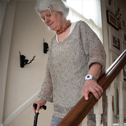 Elderly lady walking down stairs
