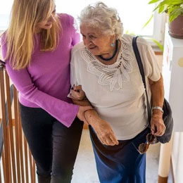 Daughter helping elderly mother home